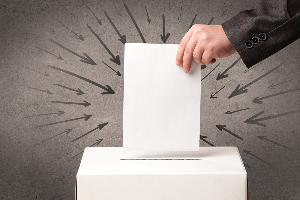 close up of a ballot box and casting vote on grungy background close up of a ballot box and casting vote on grungy background